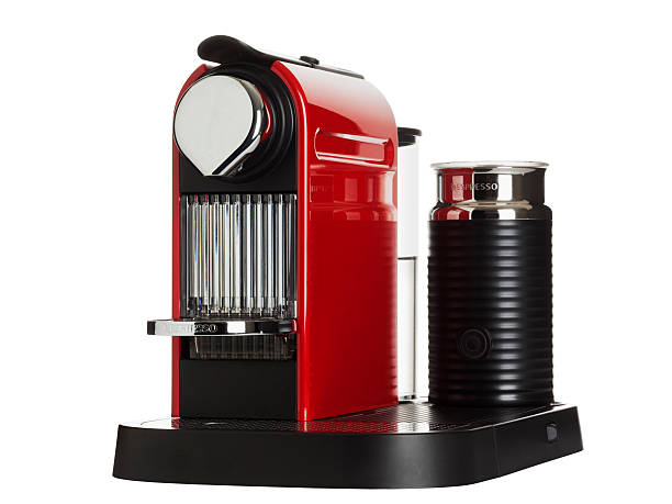"Offenbach, Germany aa February 10, 2011:NespressoA coffee machine made by Krups, model CitiZ&milk, color fire-engine red, isolated on white.Winner of the ""Red dot design award 2009"" and the ""PLUS X AWARD"". Works with NespressoA capsules."