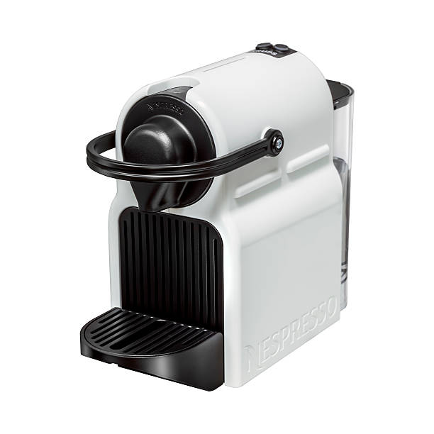 Dublin, Ireland - April 27, 2015: Dublin, Ireland 30th July 2015, Nespresso home espresso coffee machine. White espresso machine with black details clipped out and placed on white background. Shot from an angle so the rear water tank can be seen.