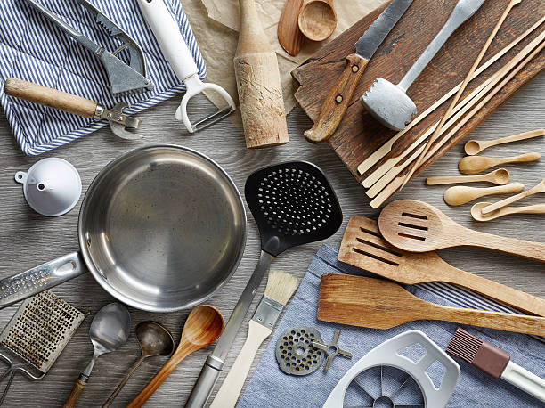various kitchen utensils on wooden table, top view